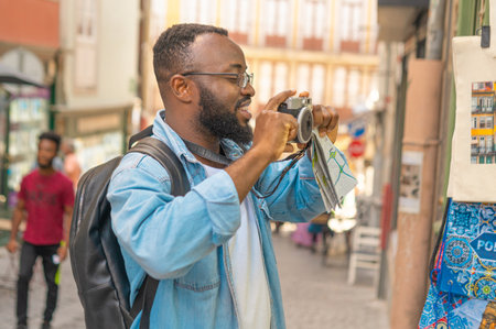 Happy tourist man against european cozy streetの写真素材