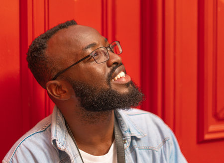 Young black man against red backgroundの写真素材