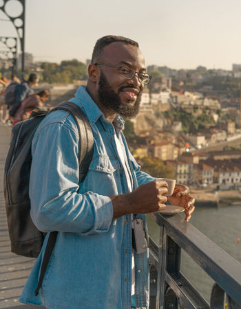 Traveller man drinking coffee on the Oporto bridge