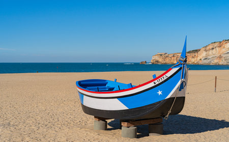 Wooden boat on the beach at Nazare, Portugal.の写真素材