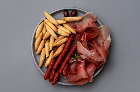 Plate with Spanish mini chorizo, jamon and picosの写真素材