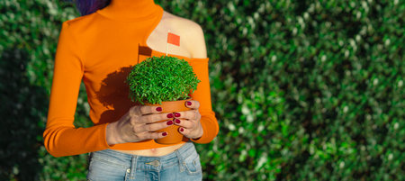 Woman with Manjerico plant outdoors, copy spaceの写真素材