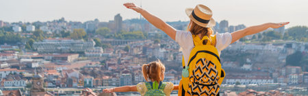 View from behind of mother and little daughter tourists in european cityの写真素材