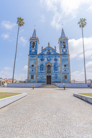 Blue tiled portuguese church with palm trees, Igreja Santa Maria de Cortegacaのeditorial素材