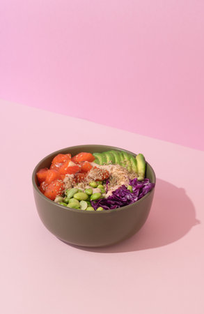 poke bowl with salmon on pink backgroundの写真素材