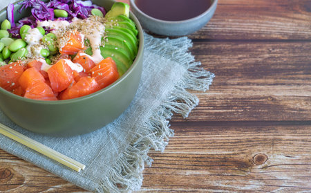 poke bowl with salmon on the wooden table