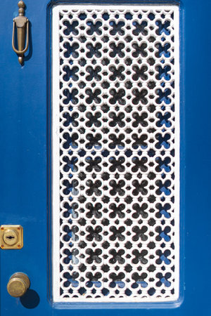 detail of blue door with white floral latticeの写真素材