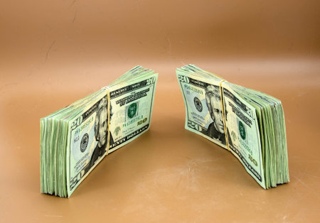 2 stacks of 20 dollar bills ready for the bank. The US dollar and saving in hard times.の写真素材