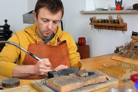 Goldsmith in workshop. Making of jewelery. Handmade. 