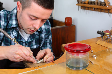 Goldsmith in workshop. Making of jewelery. Handmade. 