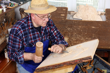Woodcarver work in his workshop.
