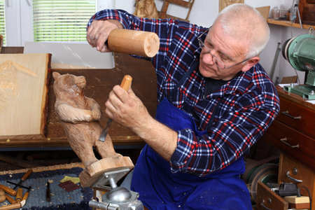 Woodcarver work in his workshop.の写真素材