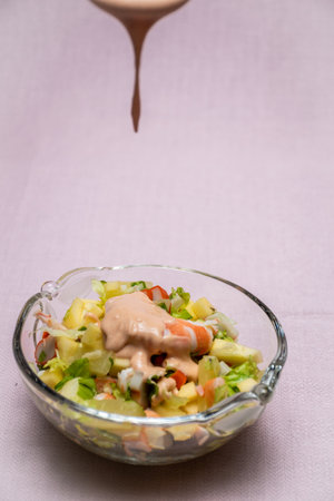 Prawn cocktail with lettuce, pink sauce, crab sticks, pineapple, apple. Glass bowl. A fresh, healthy, vegan and very healthy vegetarian appetizer and starter. Quick recipe. No staining. Children's kitchen.の写真素材