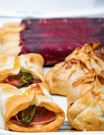 Vertical food floor for restaurant menu. Cecina de leÃ³n and ham rolls with wild asparagus. Selected focus with white background.の写真素材