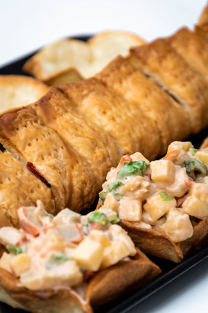 Vertical view of puff pastry and crab cocktail tops. Crab, apple, pineapple and crab salad with white background. Selected focus.の写真素材