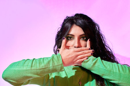 Woman covering her mouth with her hands. Stop, fight against cancer. Symbol of cancer and life....