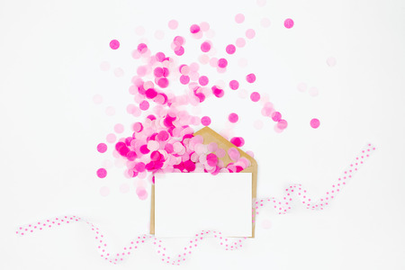 Photo frame or gift card with Pink paper confetti fly out enoverta, holiday concept.の写真素材