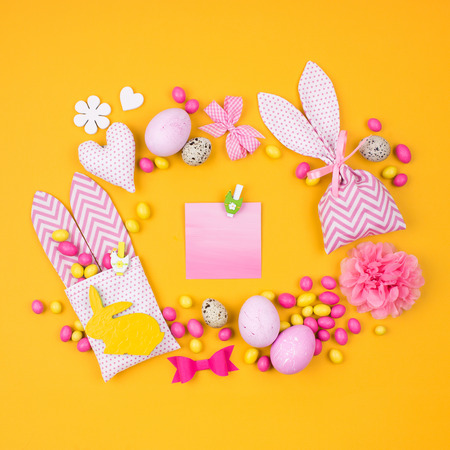 empty card for message with stylish Easter decorations on yellow backgroundの写真素材