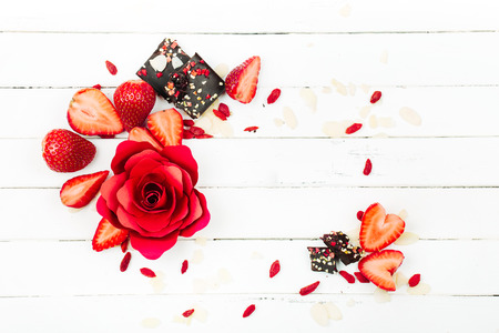 Frame of strawberry, red rose and chocolate view from above. Flat layの写真素材
