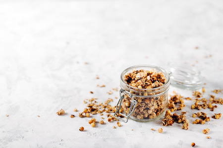 Homemade granola with nuts and seeds in glass jar for healthy breakfastの写真素材