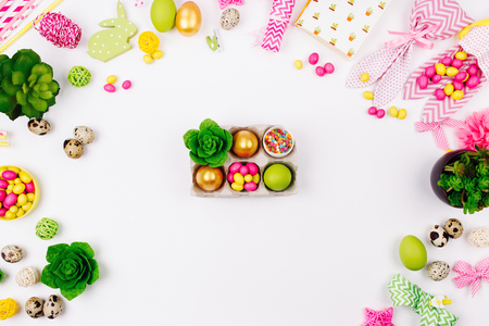 Easter eggs, candy and  succulent  in paper tray on spring decoration background. Flat lay, top viewの写真素材
