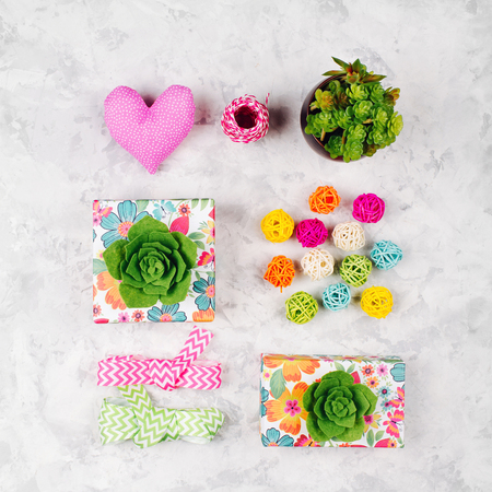 Beautiful gifts decorated with green succulents, heart, ribbons and rattan balls.  Spring backgroundの写真素材