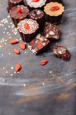 Assorted chocolates candies with nuts and goji berries with copy spaceの写真素材
