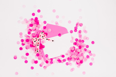 Empty card with Pink paper confetti, envelope and bow, holiday concept.の写真素材