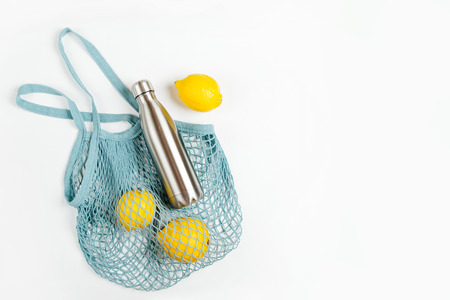 Cotton net bag with reusable metal water bottle and fruits. Sustainable lifestyle.  Eco friendly concept.の写真素材
