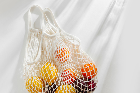 Cotton net bag with fruits. Sustainable lifestyle.  Eco friendly concept.の写真素材