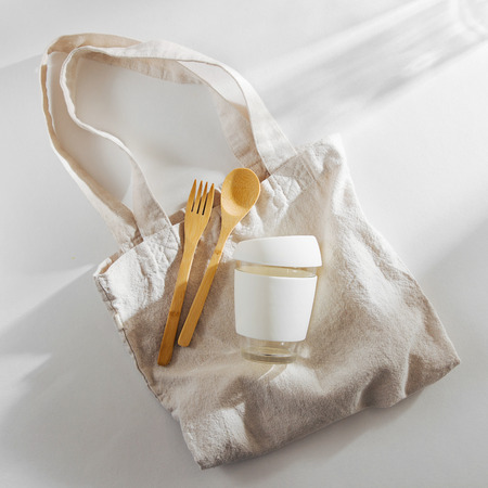 Eco friendly. Cloth shopping bag,  bamboo cutlery and  reusable coffee mug. Sustainable lifestyle.  Plastic free concept.の写真素材