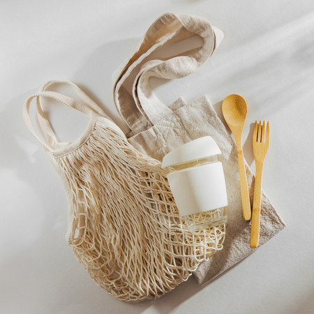 Eco friendly bamboo cutlery, eco bag and  reusable coffee mug. Sustainable lifestyle.  Plastic free concept.の写真素材