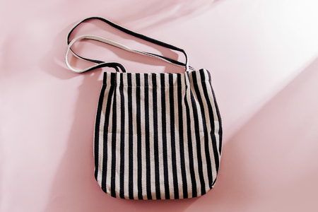 Striped cloth shopping bags on pink background.の写真素材