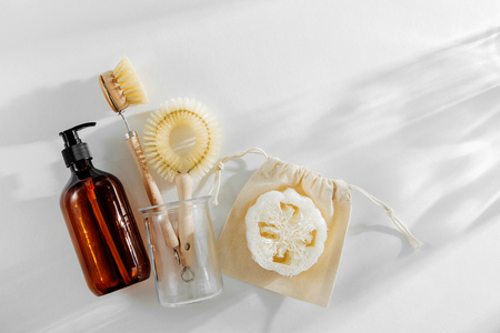 Eco friendly natural cleaning tools and products, bamboo dish brushes and soap dispenser on white background. Zero waste concept. Plastic free. Flat lay, top viewの写真素材
