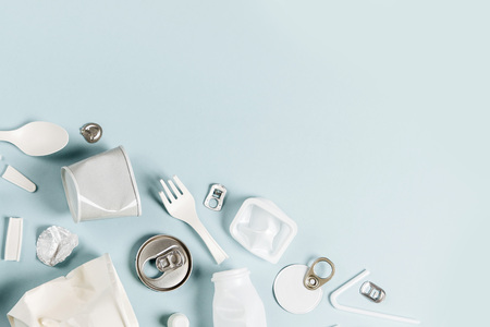 White single use plastic on  blue background.
 Environmental, pollution concept. Flat lay, top viewの写真素材