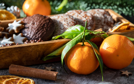 Traditional German round glazed Christmas cookies called Lebkuchen and Zimtsterne in a long wooden box.の写真素材