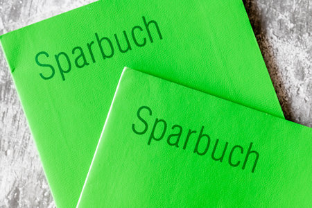Close-up of two old-fashioned passbooks with green cardboard pages, top viewの写真素材