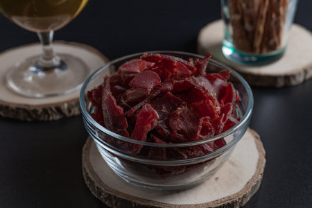 Beef jerky, dried meat, rustic country style, delicious meat snack, copy spaceの写真素材