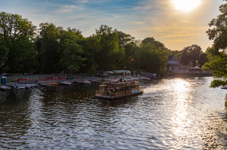 Berlin-Treptow, Germany - June 9, 2023, View of the Spree with restaurants and boat rentals in Treptower Park. The excursion boats go on the river.のeditorial素材