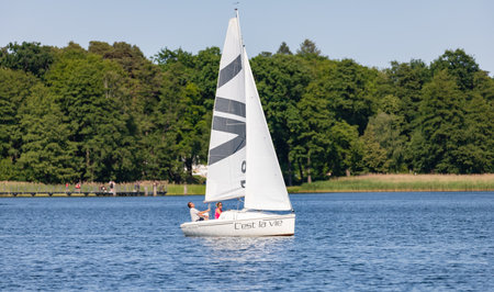 Bad Saarow, Germany - June 4, 2023, Spend a nice day with the family in the best weather on the lake with a sailing boat, copy space.のeditorial素材
