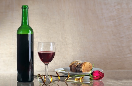 bottle with red wine and a glass against a sackingの写真素材
