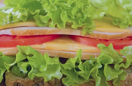 Sandwich with smoked meat, tomato and cheese.の写真素材