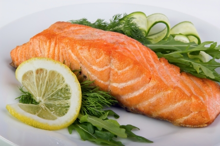 Closeup of grilled salmon with green, fresh lettuce.の写真素材