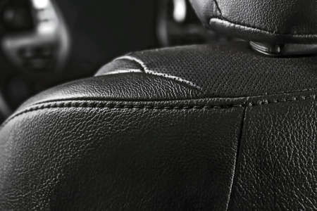 Part of the leather black perforated details of a car seat of a modern car.の写真素材