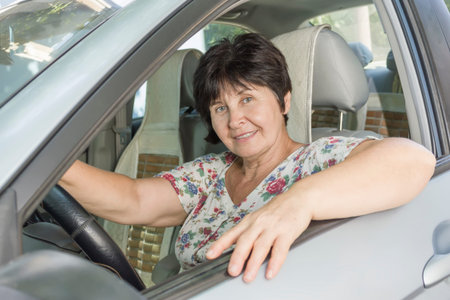 Middle-aged beautiful woman driver driving a car
