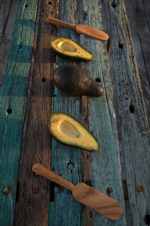 avocado decorated on wood with wooden shovels