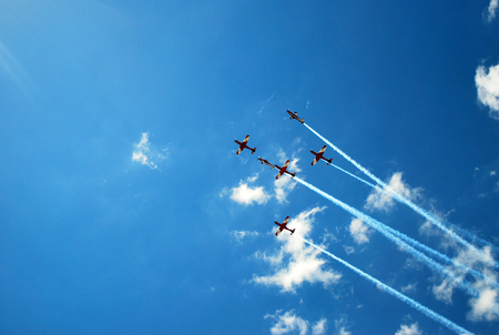 Air show with red jets across bright blue skiesのeditorial素材