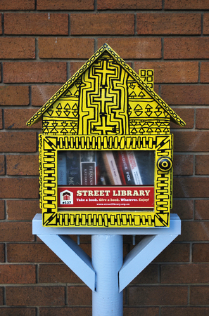 SYDNEY, AUSTRALIA - MAY 01, 2017: Street library in the form of a little yellow booth with free books. Box is used as a library exchange.のeditorial素材