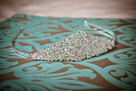 Silver sparkly bridal or prom tiara on turquoise with brown backgroundの写真素材