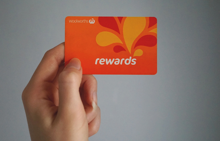 Sydney, Australia - October 15, 2017: Female caucasian hand is holding a Woolworths Rewards loyalty card, this loyalty program gives money off shopping. Woolworths Supermarkets is an Australian market leader grocery store chain.のeditorial素材